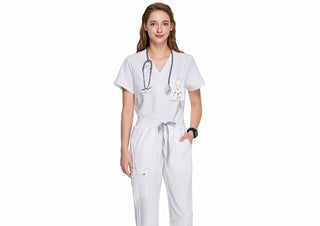 white medical scrub uniform on a woman, short sleeved top with v-neck and medical scrub pants with ribbed ankle cuffs, high waisted with adjustable drawcord