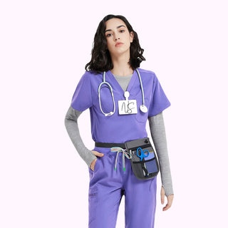 purple short sleeve medical scrub top and one chest pocket, grey underscrub, on a woman with medical scrub pants and colorful waist drawcord